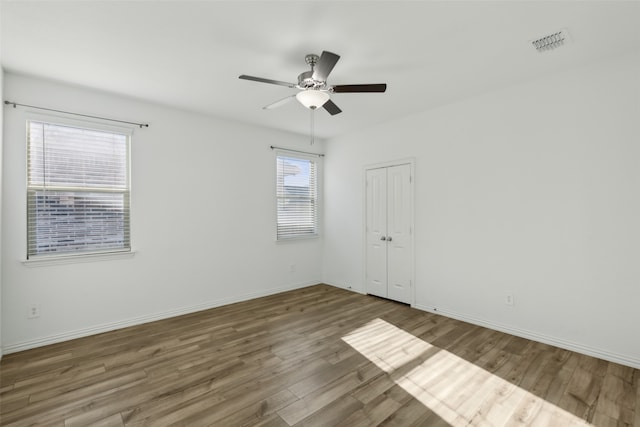 spare room with hardwood / wood-style flooring and ceiling fan