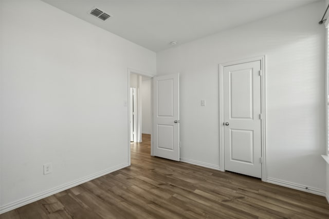 unfurnished bedroom featuring dark hardwood / wood-style floors