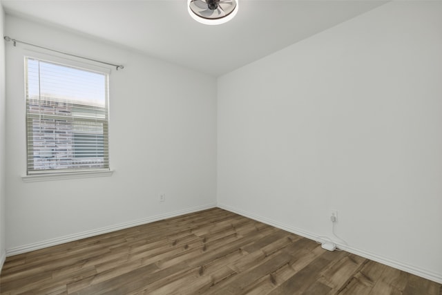 spare room with dark wood-type flooring