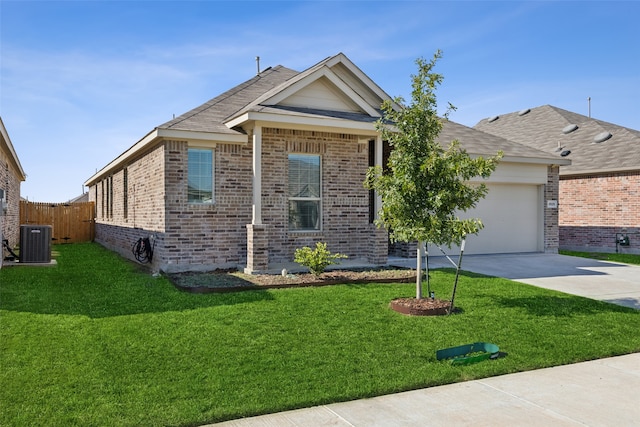 ranch-style house featuring a garage, a front lawn, and central AC