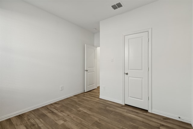 unfurnished bedroom featuring dark hardwood / wood-style floors