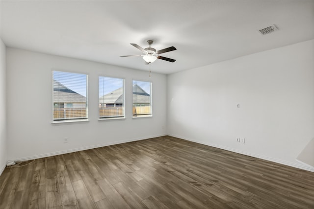 spare room featuring ceiling fan and dark hardwood / wood-style flooring