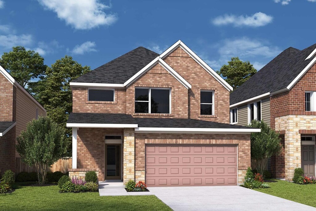 view of front of house featuring a garage and a front yard