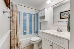 full bathroom with vanity, toilet, tile patterned flooring, and shower / bathtub combination with curtain