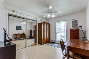 home office featuring light hardwood / wood-style flooring and ceiling fan