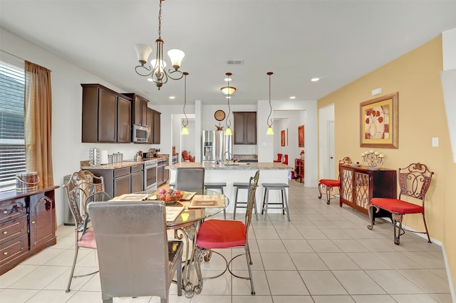 tiled dining space with a notable chandelier and sink