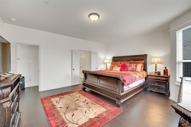 bedroom with dark wood-type flooring