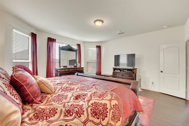 bedroom with dark hardwood / wood-style floors