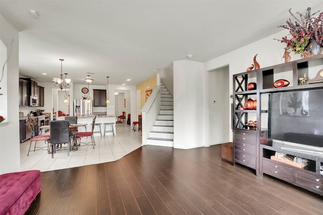 living room featuring an inviting chandelier and light hardwood / wood-style floors