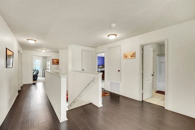 corridor with dark hardwood / wood-style floors