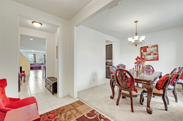 dining space featuring an inviting chandelier and light carpet