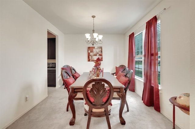 dining space featuring light carpet and a notable chandelier