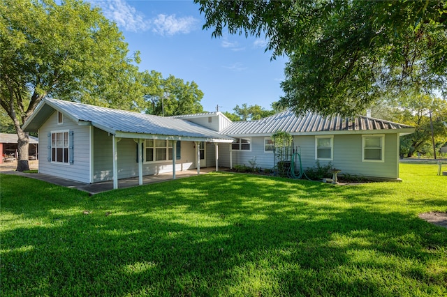 rear view of house with a lawn