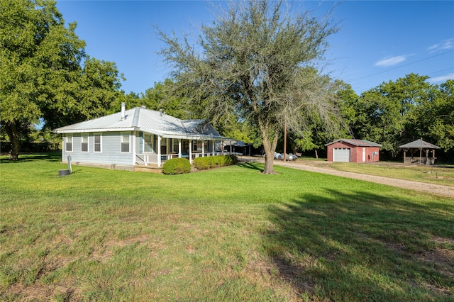 exterior space with an outbuilding, a garage, and a front yard