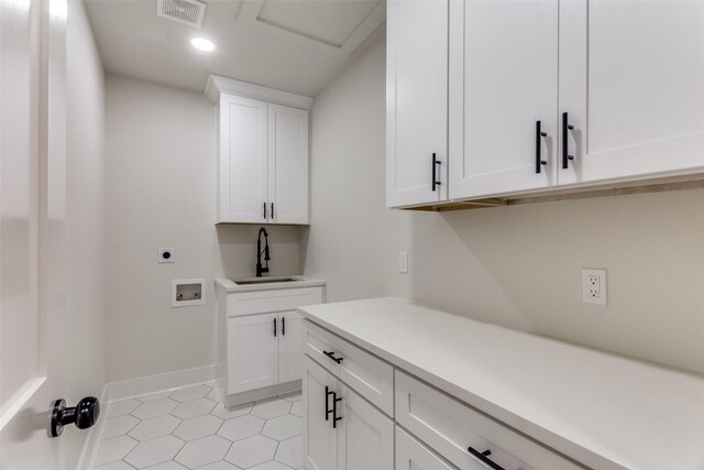 clothes washing area featuring hookup for a washing machine, cabinets, light tile patterned floors, sink, and electric dryer hookup