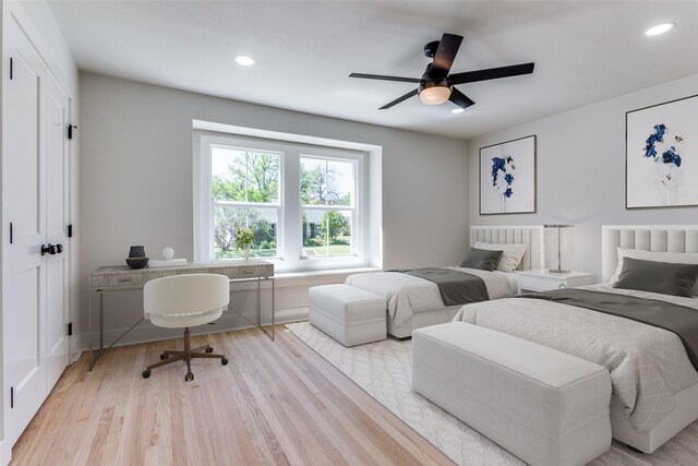 bedroom featuring ceiling fan, a closet, and light hardwood / wood-style floors