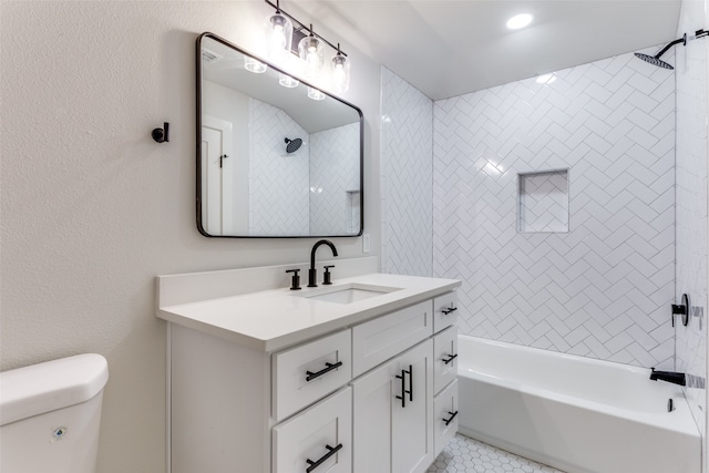 full bathroom with tile patterned floors, tiled shower / bath, toilet, and vanity