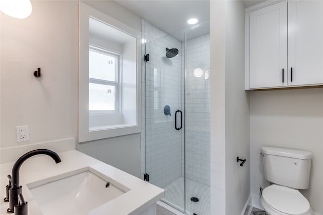 bathroom with vanity, toilet, and an enclosed shower