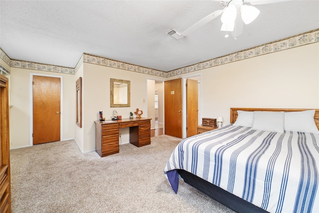 carpeted bedroom with a textured ceiling and ceiling fan