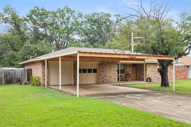 view of front of property with a front yard, a carport, and a garage