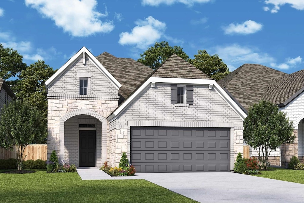 view of front of property with a garage and a front yard