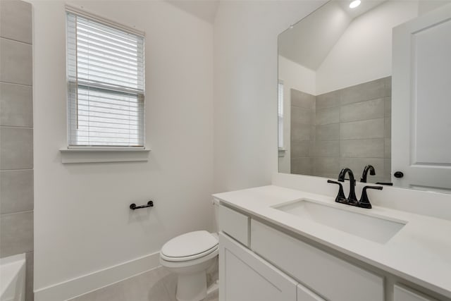 bathroom with toilet, a tub to relax in, vanity, and tile patterned flooring