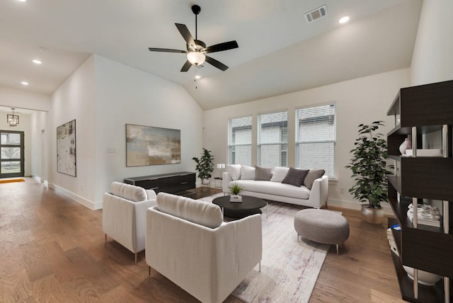 living room featuring high vaulted ceiling, hardwood / wood-style floors, and ceiling fan