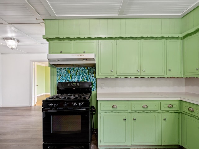 kitchen with hardwood / wood-style flooring, green cabinetry, and gas stove