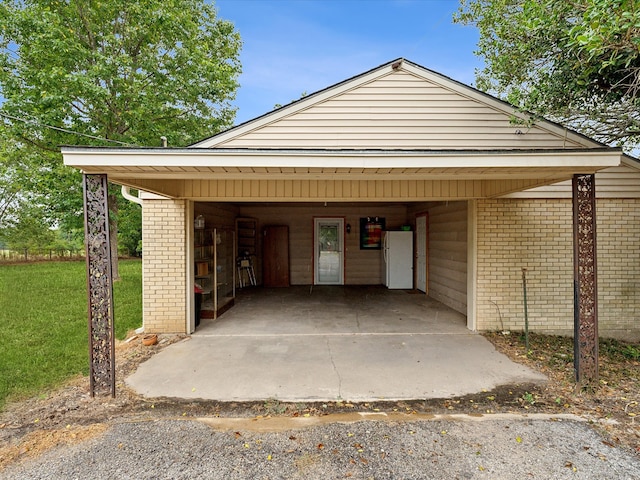 garage with a lawn and a carport