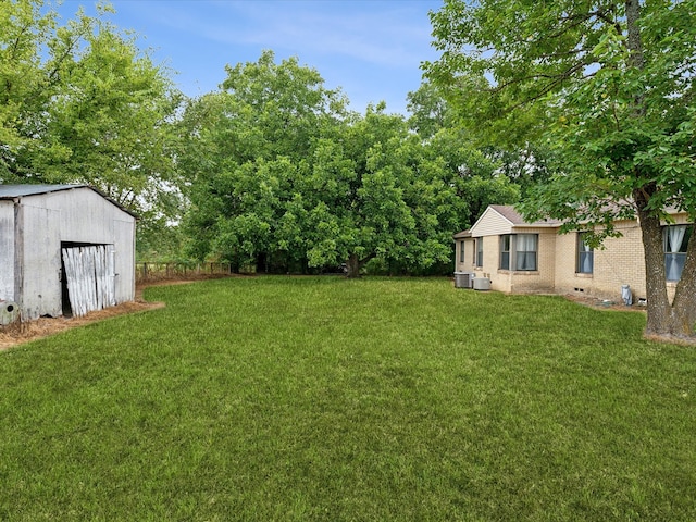 view of yard featuring a storage unit and cooling unit