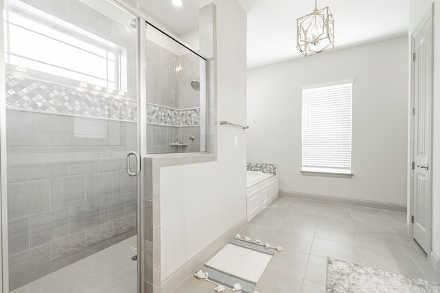 bathroom with a chandelier, tile patterned floors, and shower with separate bathtub