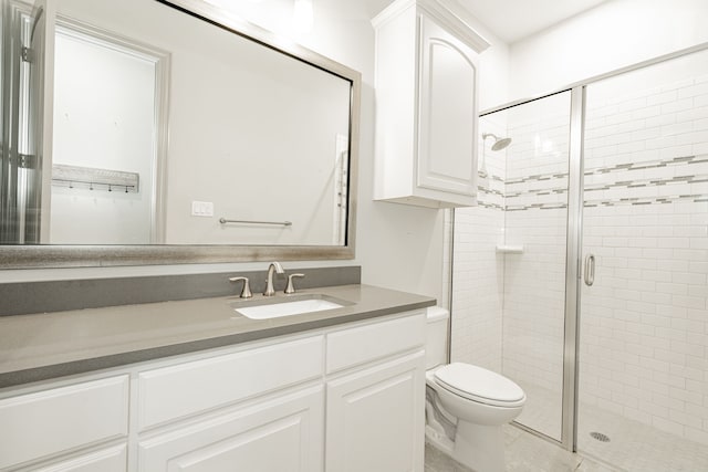 bathroom featuring vanity, toilet, and an enclosed shower