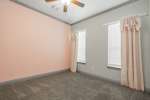 carpeted empty room with ceiling fan and crown molding