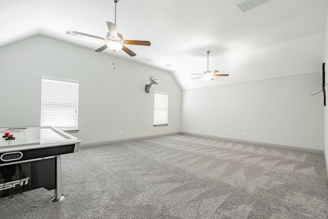 game room with lofted ceiling, ceiling fan, and light colored carpet