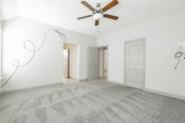 carpeted spare room featuring ceiling fan and vaulted ceiling