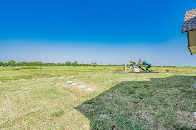 view of yard featuring a rural view and a playground