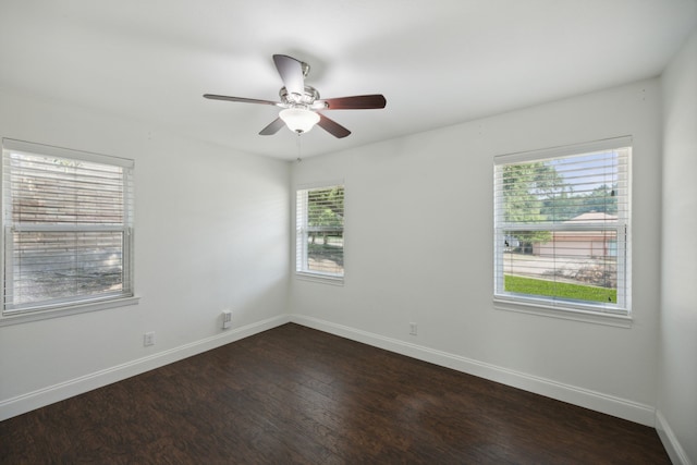 unfurnished room featuring dark hardwood / wood-style floors, plenty of natural light, and ceiling fan