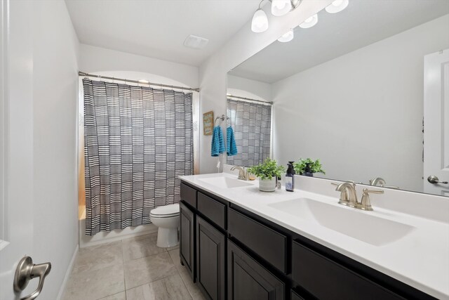 full bathroom with tile patterned floors, toilet, shower / tub combo with curtain, and vanity