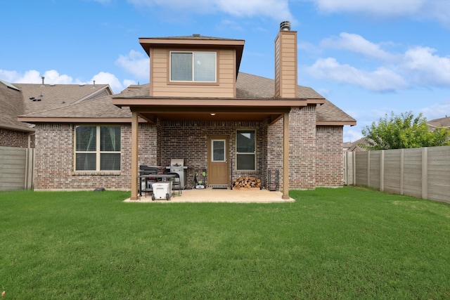 back of house featuring a yard and a patio