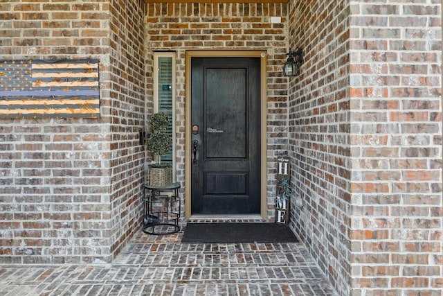 property entrance with brick siding