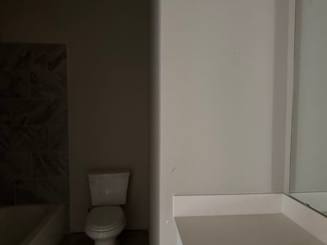 bathroom with a bath and toilet