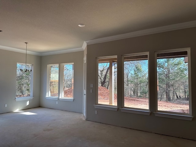 unfurnished room featuring crown molding, plenty of natural light, and an inviting chandelier