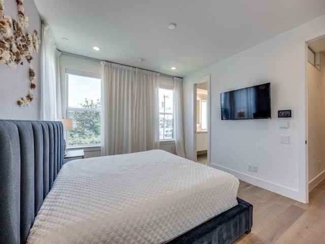 bedroom featuring light wood-type flooring and multiple windows