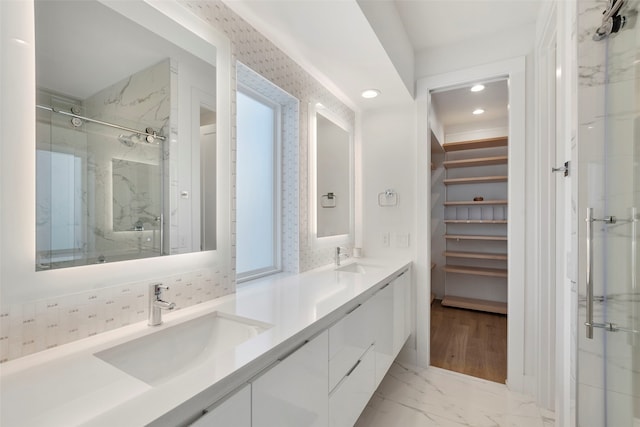 bathroom with walk in shower and vanity