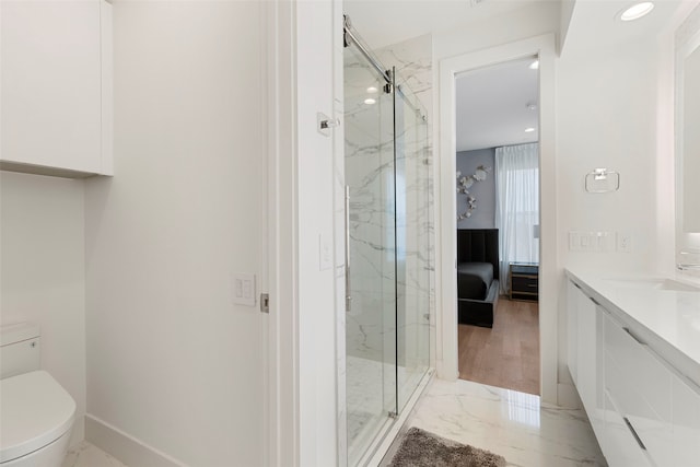 bathroom with vanity, toilet, hardwood / wood-style floors, and a shower with door