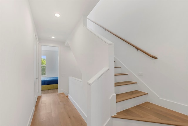 staircase featuring wood-type flooring