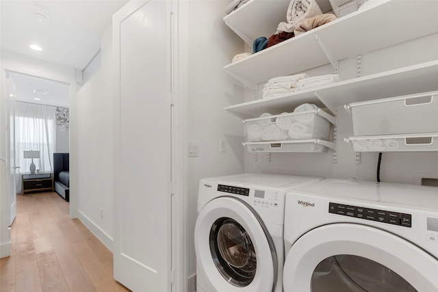 laundry area featuring light wood-type flooring and independent washer and dryer