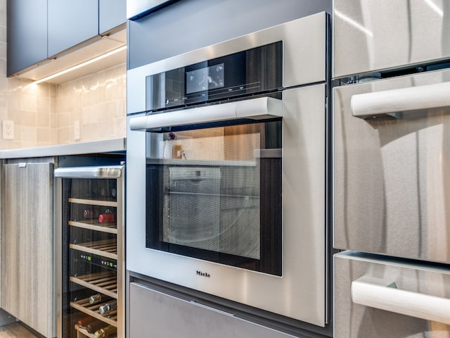 kitchen with tasteful backsplash and beverage cooler