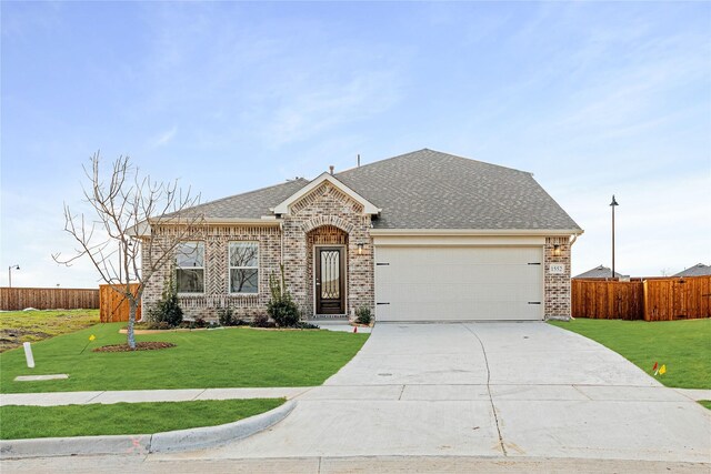 single story home with a garage and a lawn