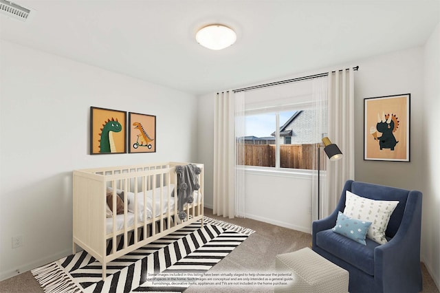 bedroom featuring a nursery area and carpet flooring